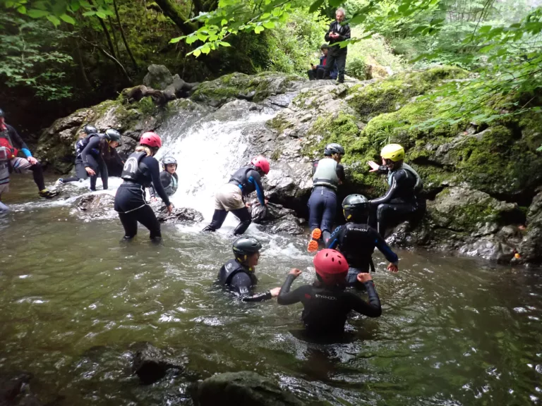 Group of scouts scrambling up a gorge in South Wales