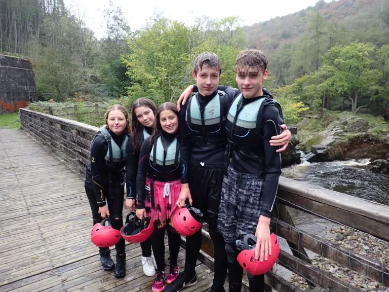 Two boys and three girls on a bridge during a gorge walking activity in South Wales